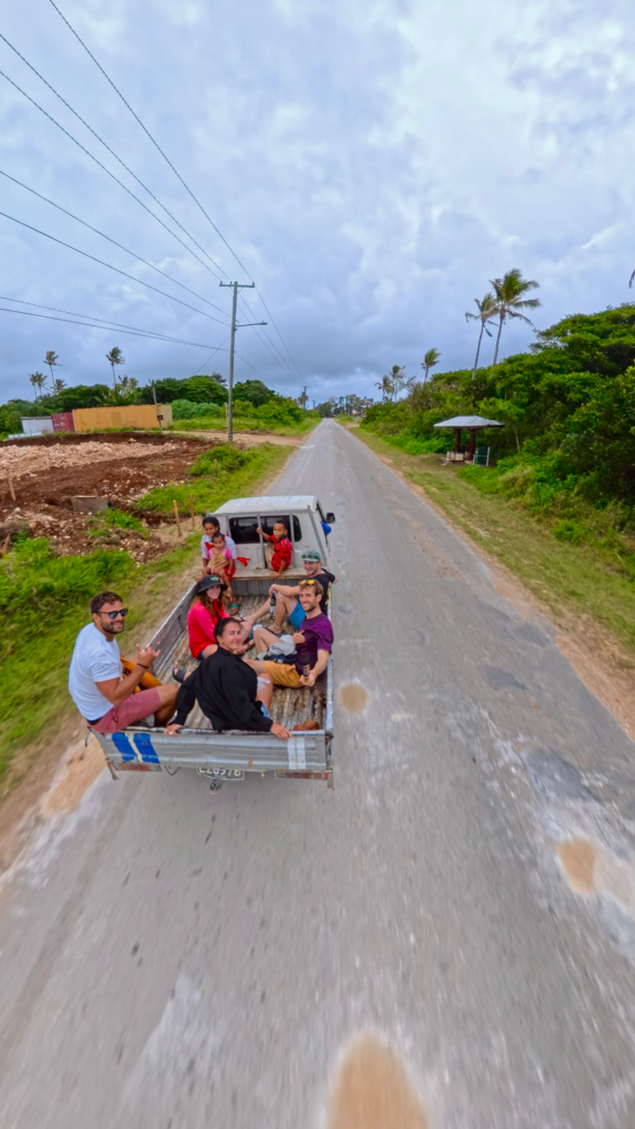 Is Tonga worth visiting? Group of 5 hitchhiking in the back of a pickup truck in tonga