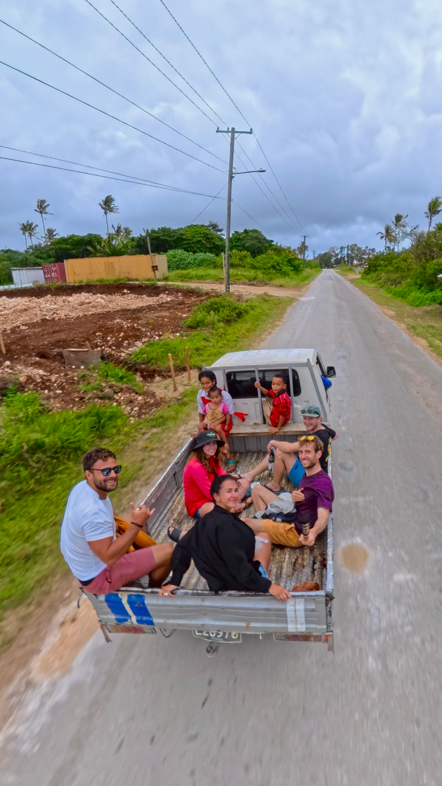 Is Tonga worth visiting? Group of 5 hitchhiking in the back of a pickup truck in tonga