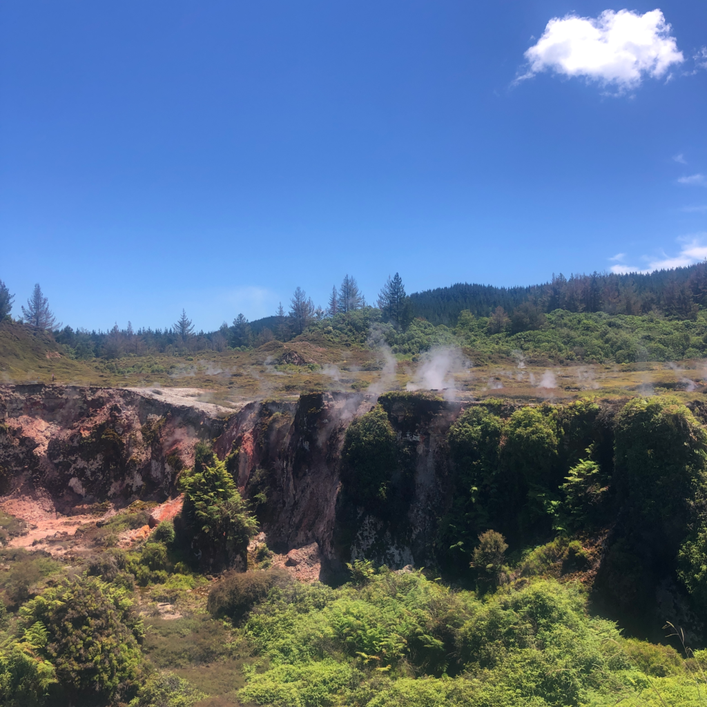 craters of the moon steaming geothermal activity in taupo NZ. blue skies and big steaming crater