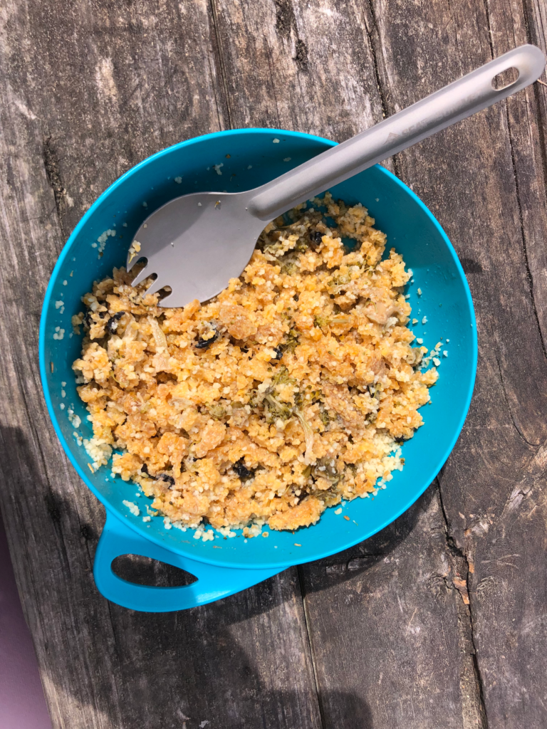 ultimate guide to hiking the queen charlotte track in 4 days, eating good food! Photo of polenta in a blue camping bowl