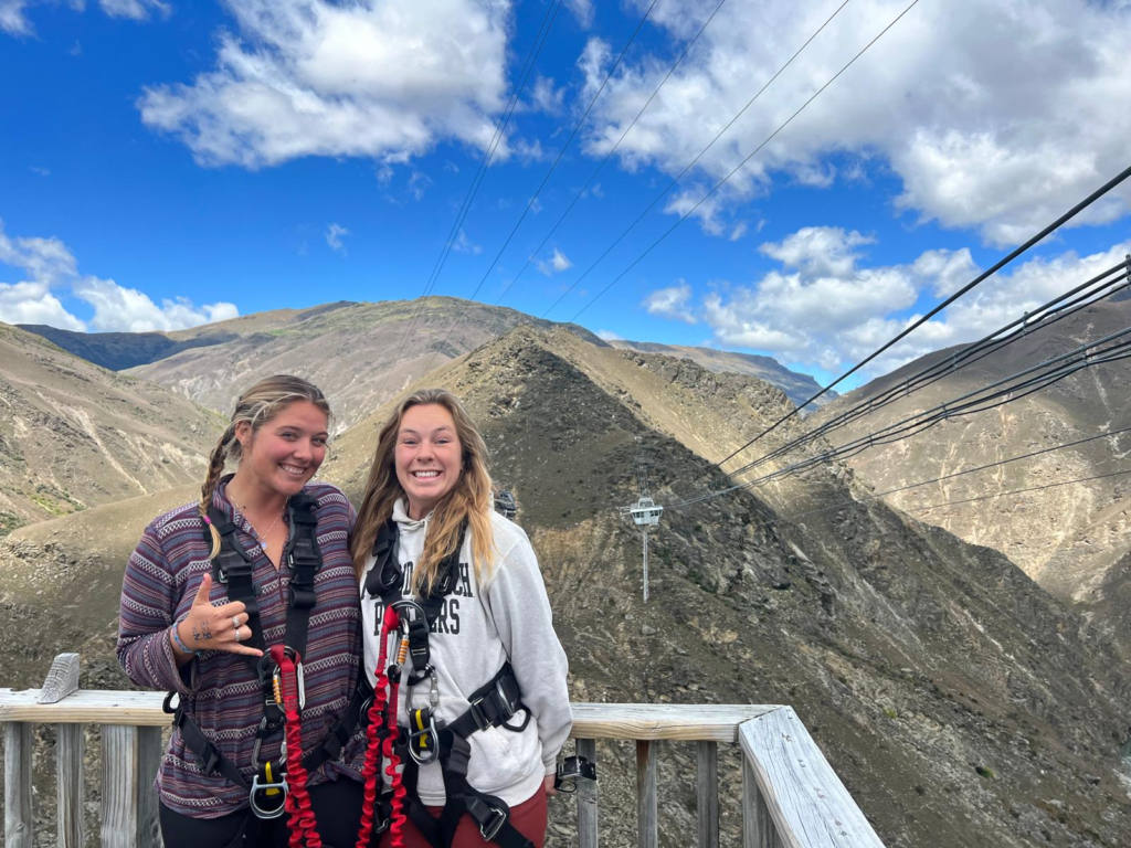 what to do in queenstown , the nevis bungee jump. Two women stand on a bungee jump platform