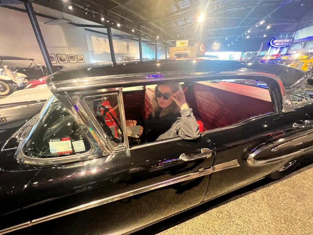 how to spend 2 days in nelson, go to the nelson classic car museum. woman in black cadillac.