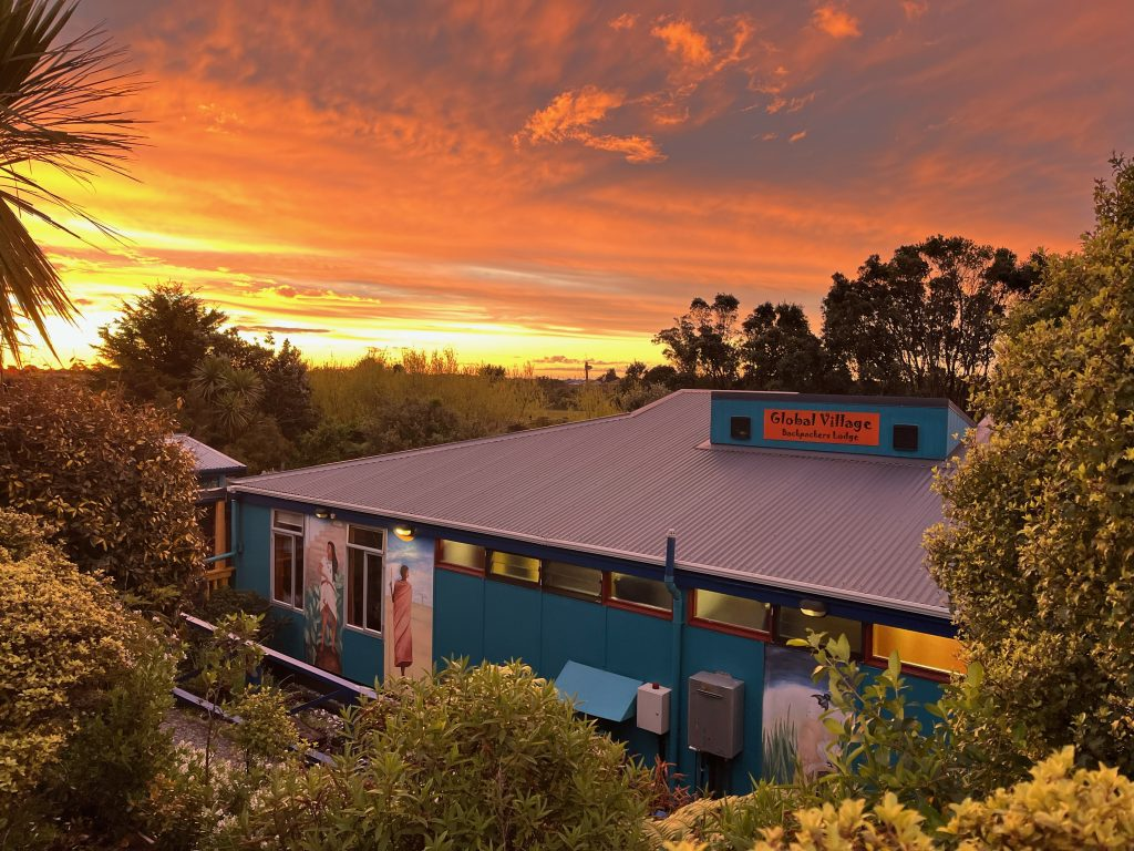 1-day greymouth itinerary view of global village hostel at sunset