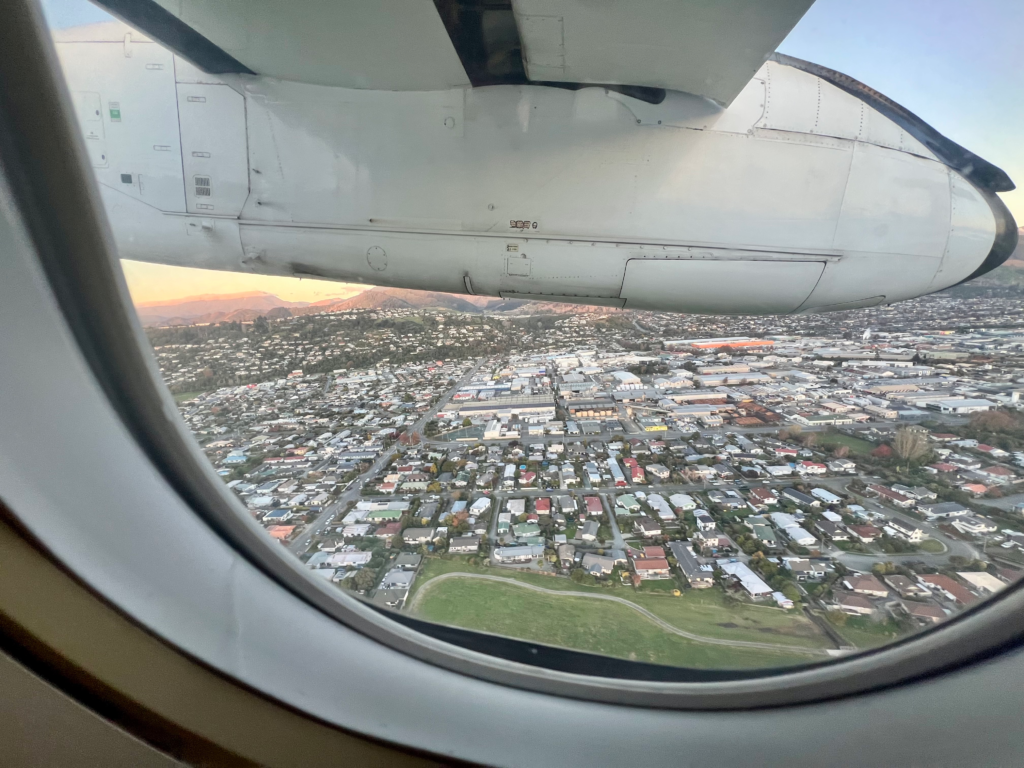 view from an airplane window of suburbs of nelson nz