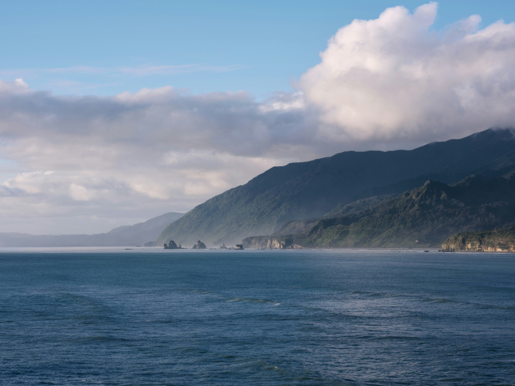 1-day greymouth itinerary photo of body of water with mountain in background