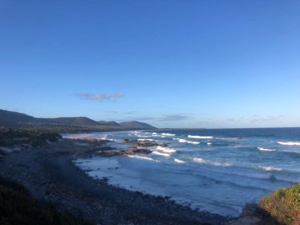 Coastline of the friendly beaches tasmania with long rolling waves crashing on beach